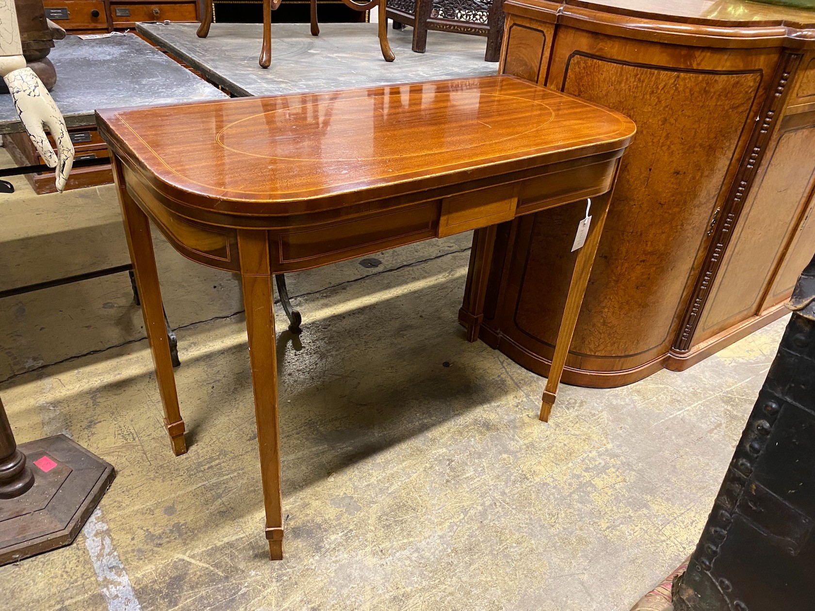 A George III style banded mahogany D shaped folding tea table, width 91cm, depth 46cm, height 74cm